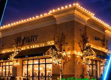 Commercial building outlined in warm white holiday lights